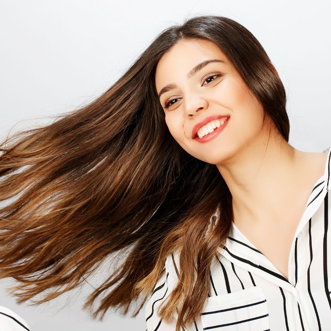 photo of a smiling woman with beautiful hair